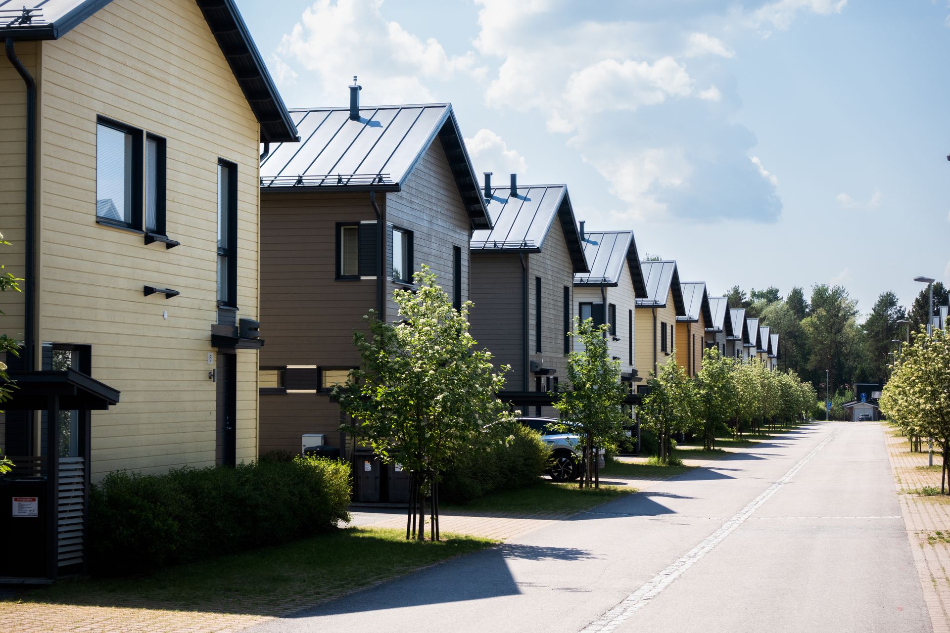 Modern wood-sided rowhouses with metal roofs in Pacific Northwest style — townhome middle housing built in King and Snohomish County