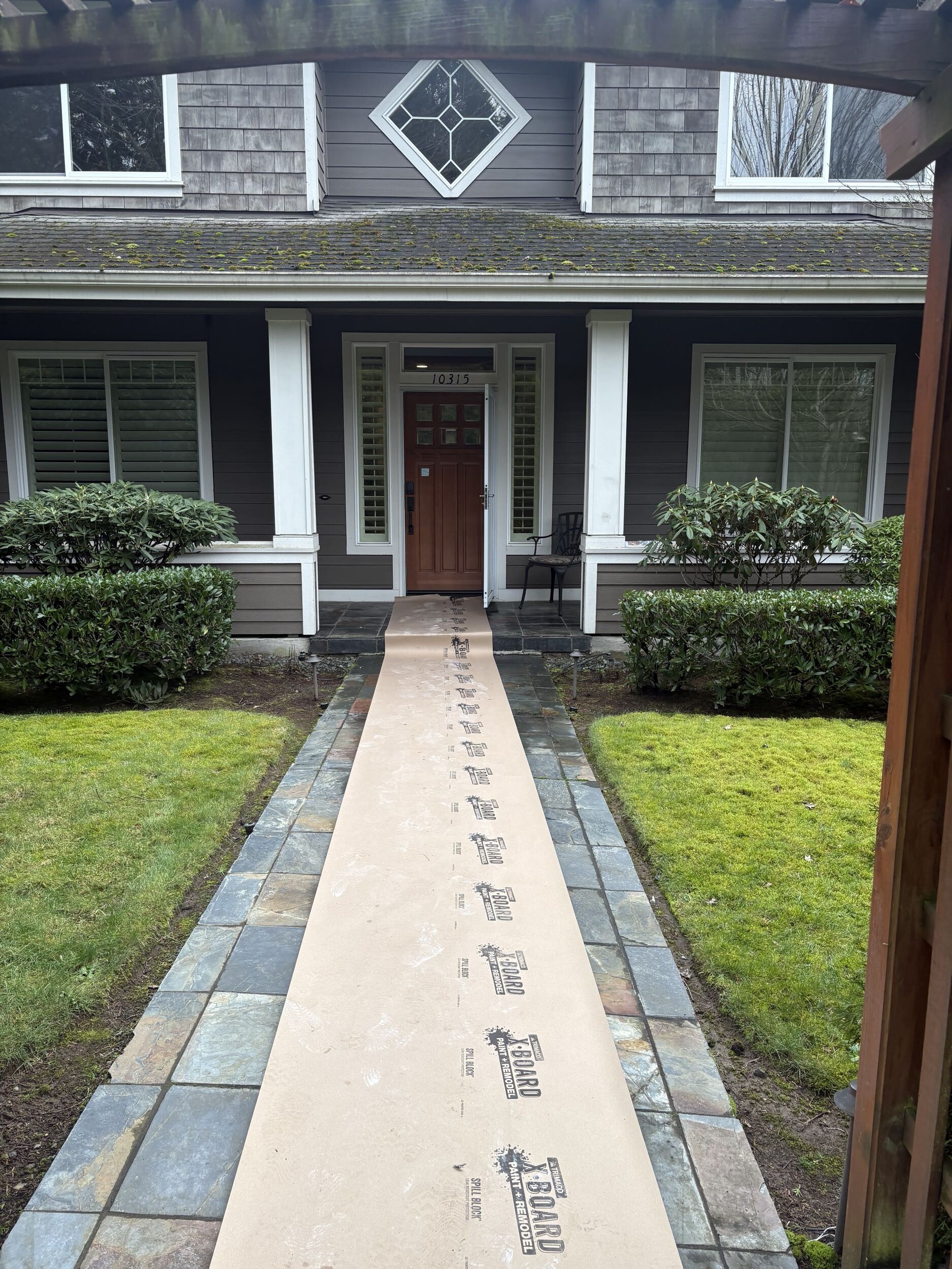 Temporary floor protection and dust barriers installed before bathroom demolition in occupied Bothell home