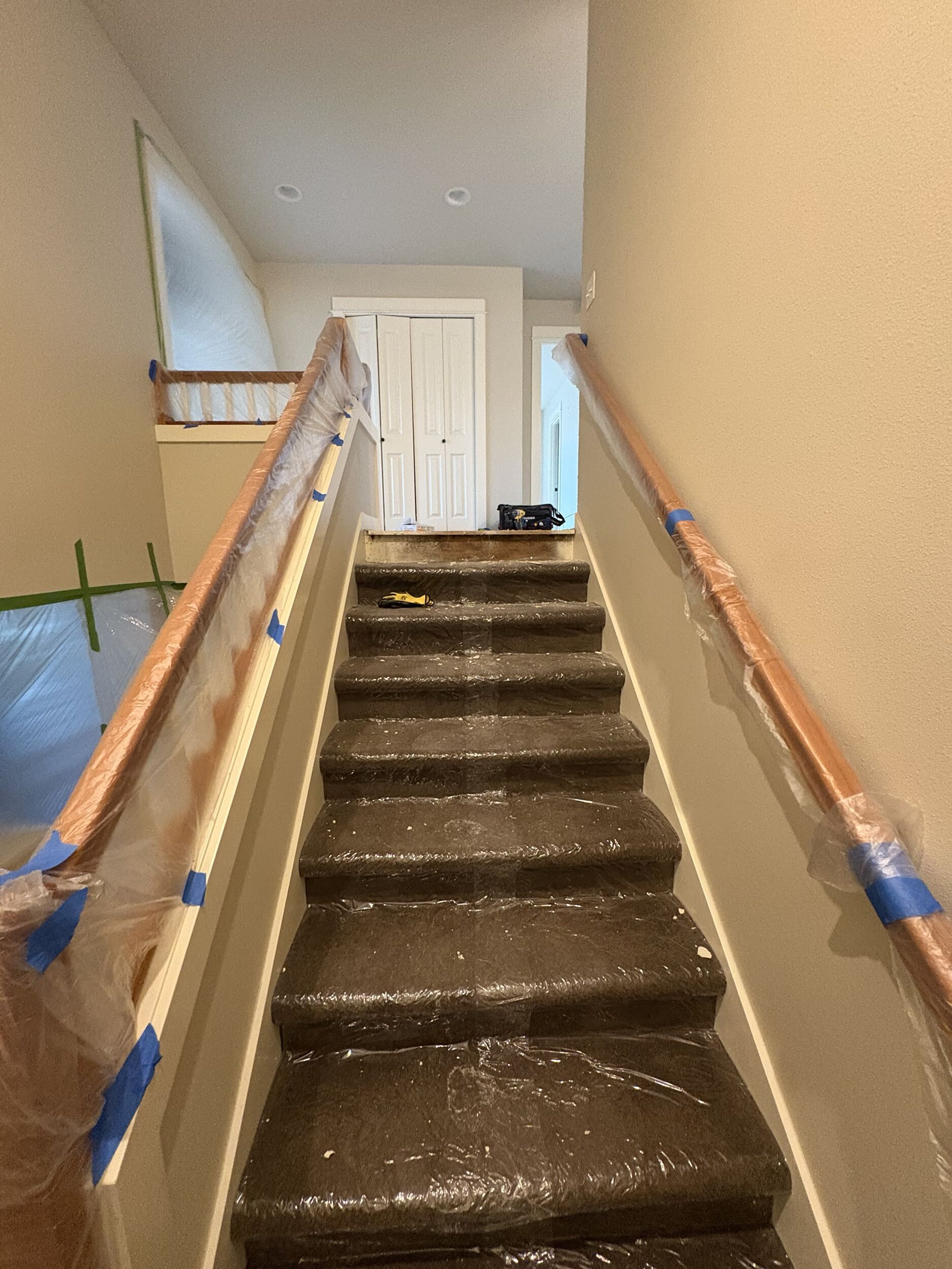 Dust barrier zip walls isolating second floor bathroom demolition work zone