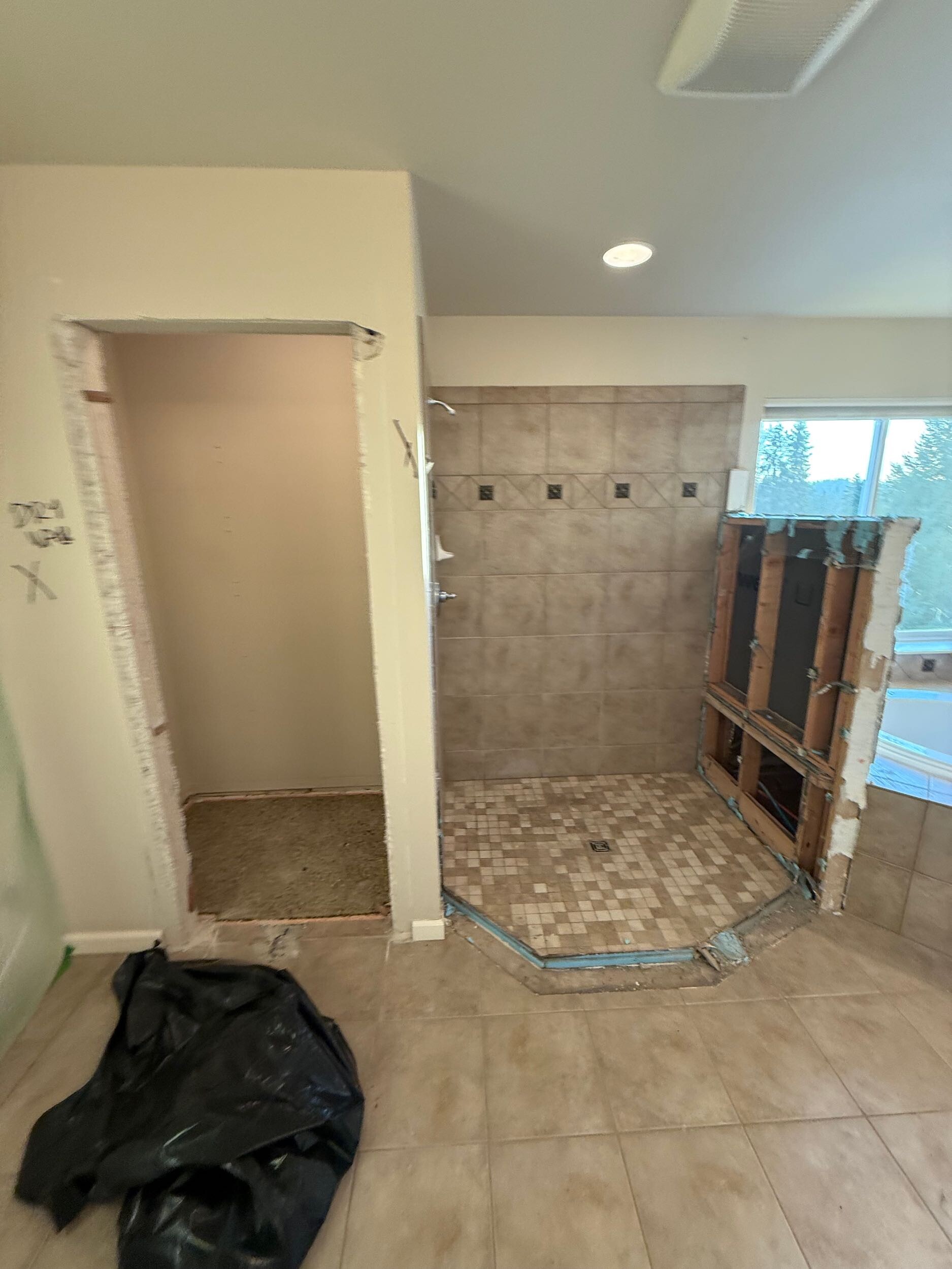 Controlled demolition opening for new plumbing routing in occupied home remodel