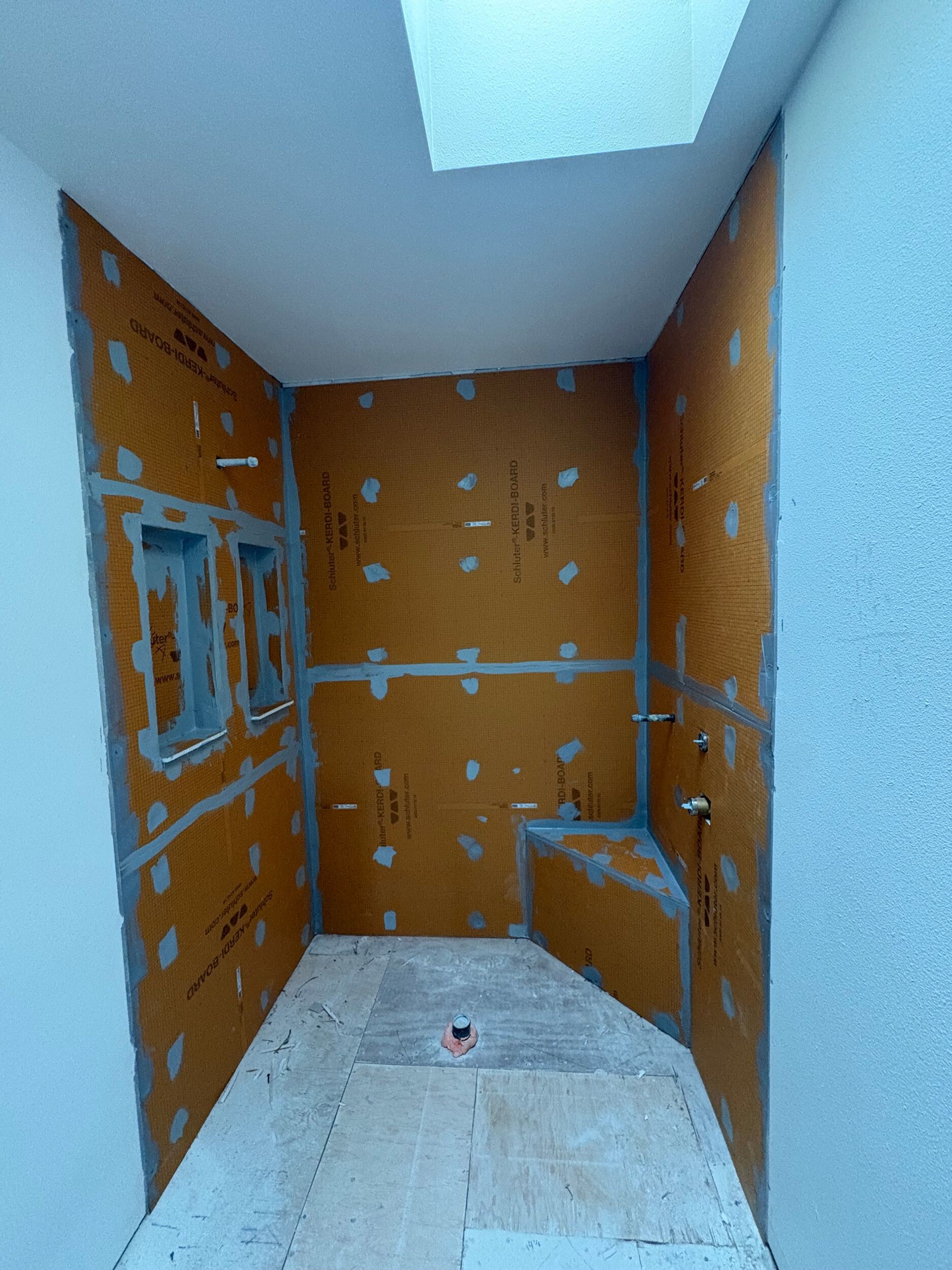 Schluter Kerdi waterproofing membrane behind shower tile Bothell remodel